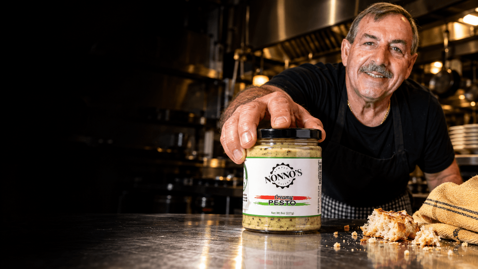 Stefano leaning across the restaurant counter with his Creamy Pesto.