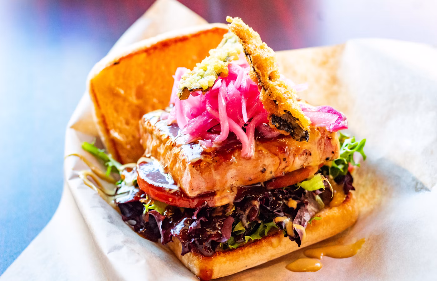 Fish sandwich with greens on a toasted roll